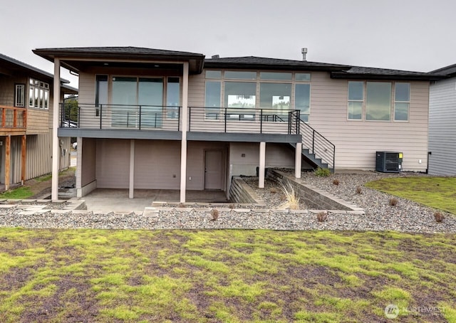 rear view of property featuring central AC, a patio, and a yard