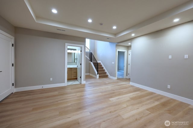 basement with light hardwood / wood-style floors