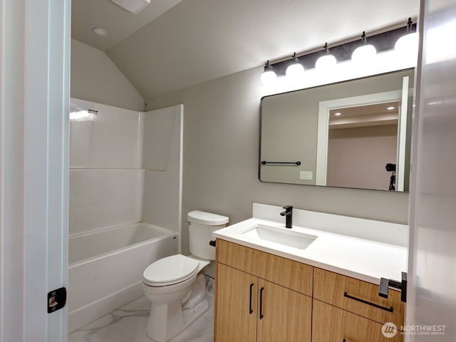 full bathroom with toilet, lofted ceiling, vanity, and washtub / shower combination