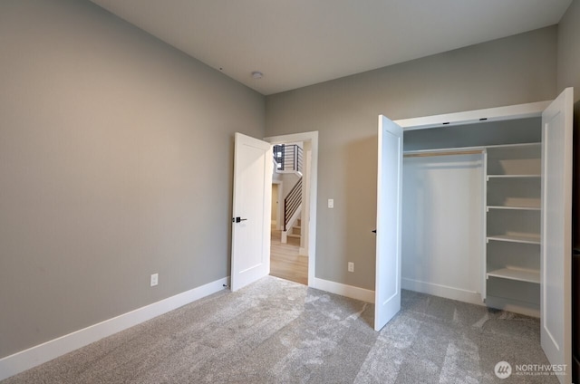 unfurnished bedroom with light carpet and a closet