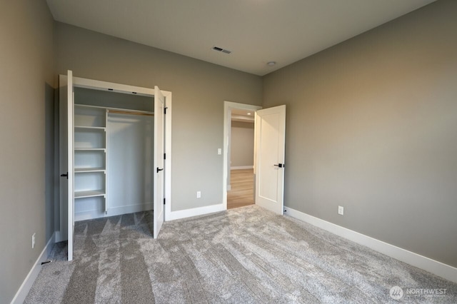 unfurnished bedroom with carpet floors and a closet