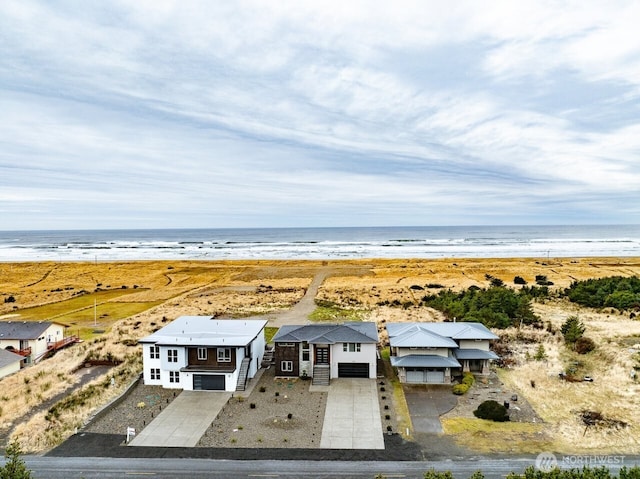 drone / aerial view with a water view and a view of the beach