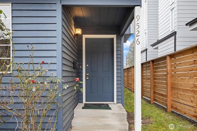 view of exterior entry with fence