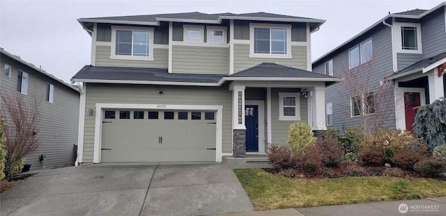 view of front of home with driveway, a garage, and roof with shingles