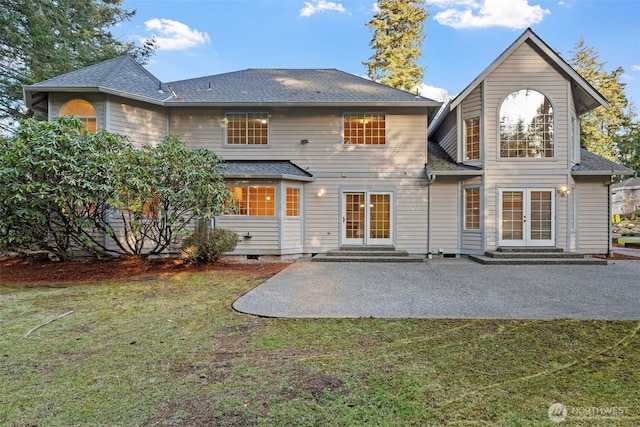 rear view of property with french doors, a yard, and a patio area