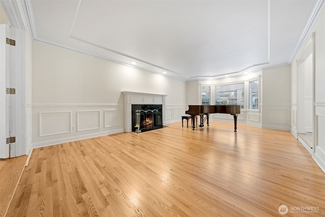 unfurnished living room featuring crown molding and light hardwood / wood-style flooring