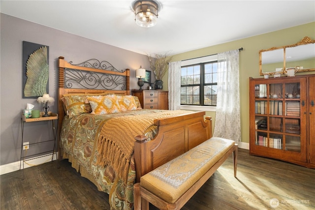 bedroom featuring dark wood-style floors and baseboards