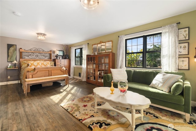 bedroom featuring dark wood-style flooring and baseboards