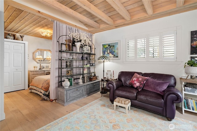 living area featuring wooden ceiling, light wood-style flooring, and beam ceiling