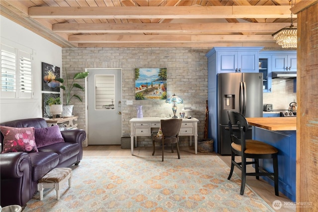 living room with wood ceiling, beam ceiling, and brick wall