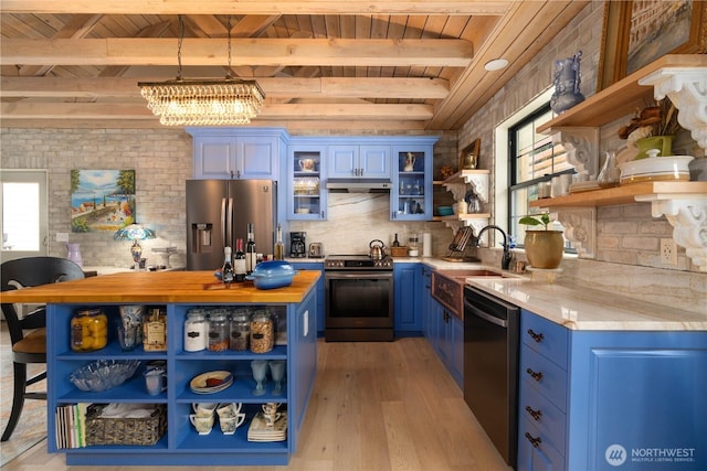 kitchen with open shelves, light countertops, appliances with stainless steel finishes, glass insert cabinets, and blue cabinets