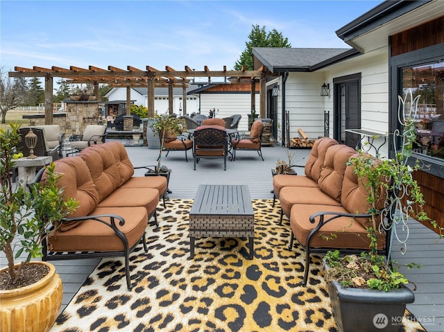 view of patio / terrace featuring a deck, an outdoor living space with a fire pit, and a pergola