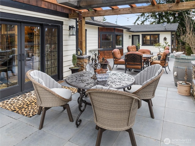 view of patio with an outdoor fire pit, french doors, outdoor dining area, and a pergola