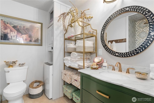 bathroom with vanity, toilet, and tile patterned floors