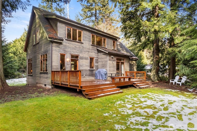 back of property featuring a yard and a wooden deck