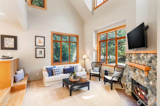 carpeted living room with a high ceiling and a fireplace