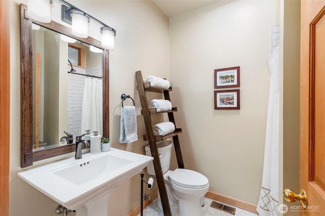 bathroom featuring sink and toilet