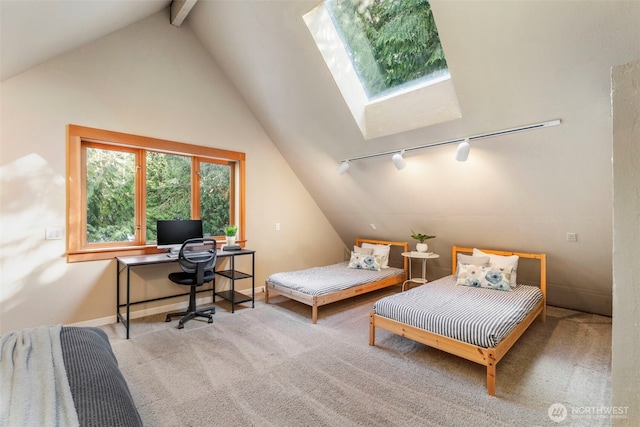 bedroom with track lighting, carpet flooring, and lofted ceiling with skylight