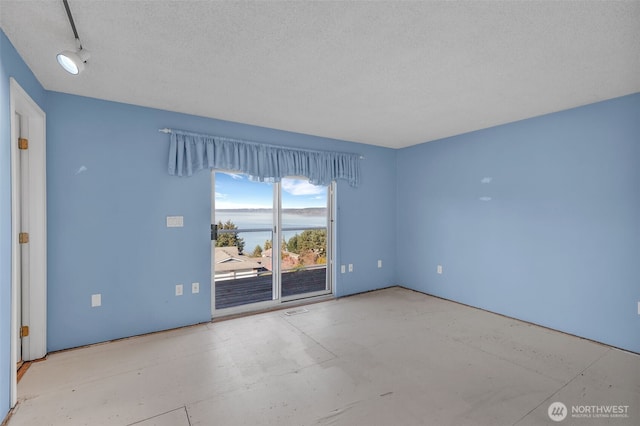 unfurnished room featuring visible vents and a textured ceiling