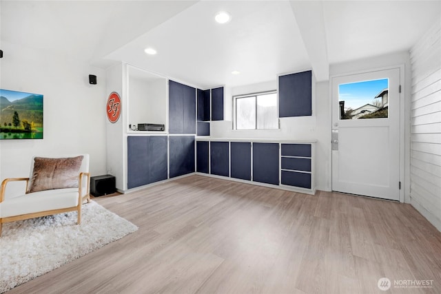 interior space with beamed ceiling and light hardwood / wood-style floors