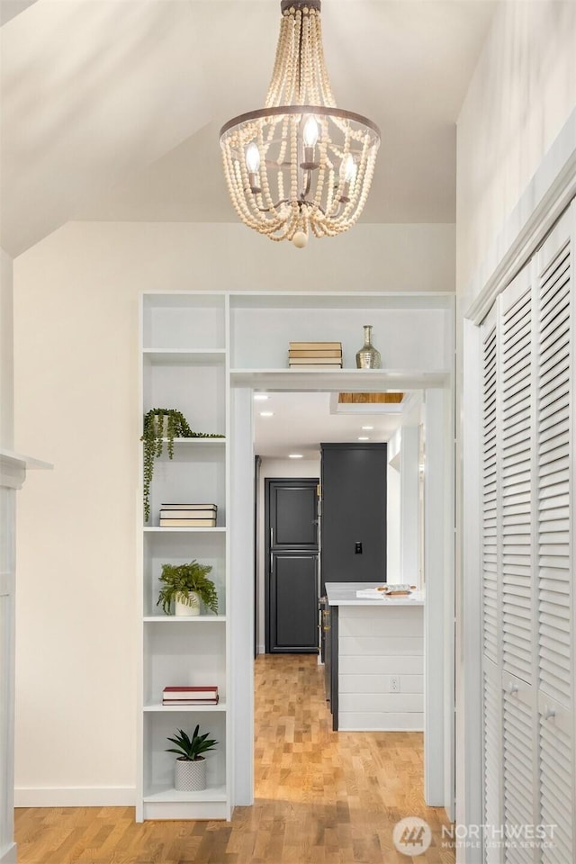 interior space with light wood-type flooring and a chandelier