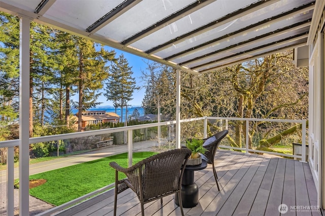 unfurnished sunroom with a water view