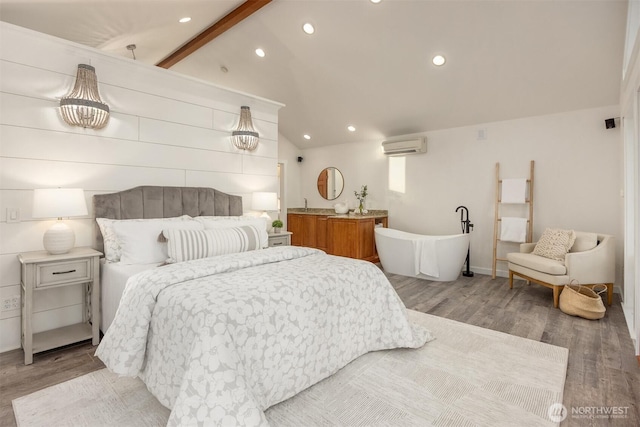 bedroom with a wall unit AC, vaulted ceiling with beams, and wood-type flooring