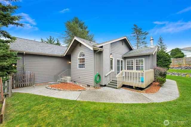 rear view of property featuring crawl space, a yard, and fence