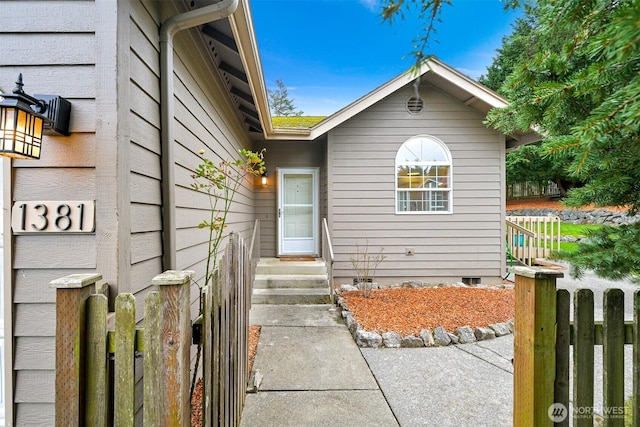 view of front of house with entry steps, fence, and crawl space