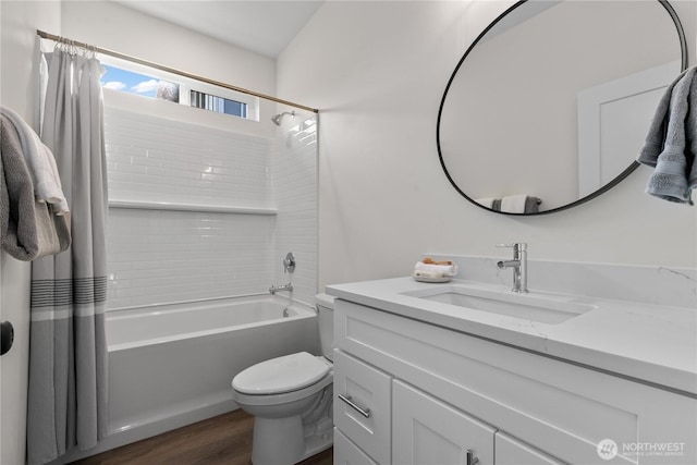 bathroom featuring vanity, shower / tub combo, toilet, and wood finished floors