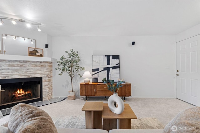 carpeted living room with a tile fireplace