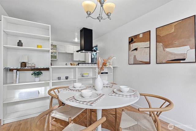 dining room with an inviting chandelier and light hardwood / wood-style floors