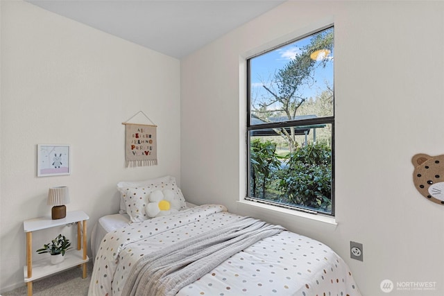 bedroom featuring multiple windows and carpet flooring