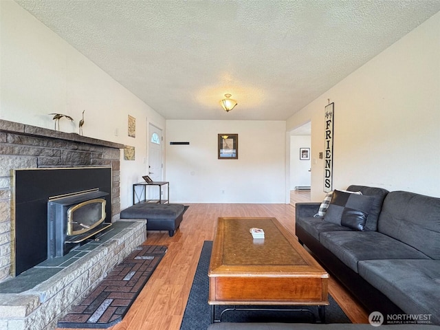 living room featuring a textured ceiling and hardwood / wood-style floors