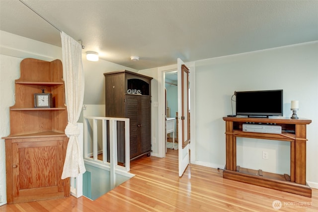 interior space with an upstairs landing and wood finished floors