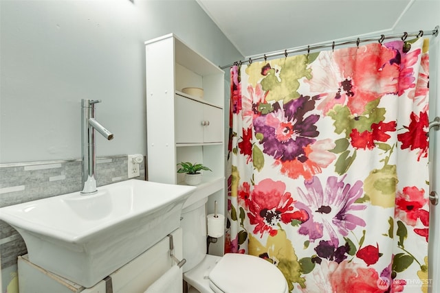 bathroom featuring curtained shower, tile walls, toilet, wainscoting, and vanity