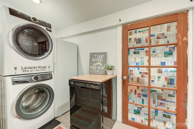 laundry room featuring laundry area, wine cooler, and stacked washer / drying machine