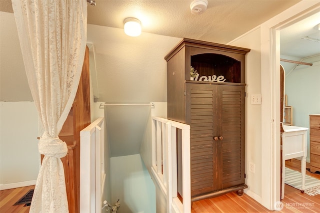 interior space with baseboards and wood finished floors