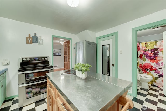 kitchen featuring stainless steel countertops, tile patterned floors, visible vents, and appliances with stainless steel finishes