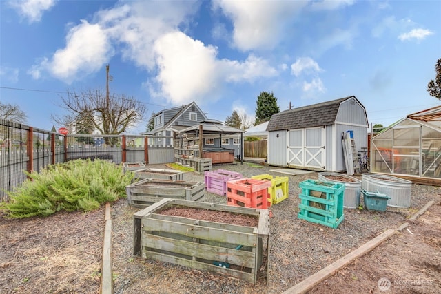 view of yard featuring an exterior structure, a storage shed, a fenced backyard, an outdoor structure, and a vegetable garden