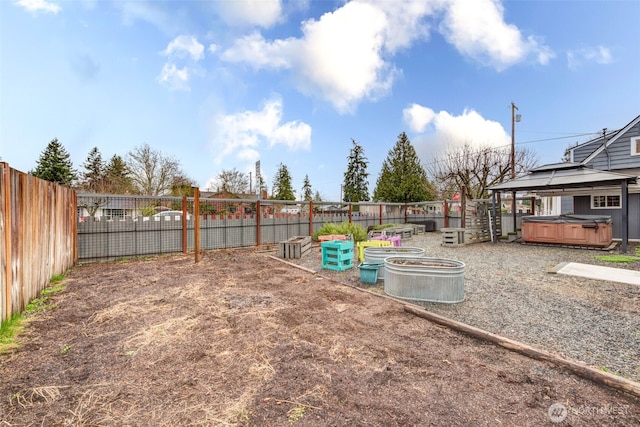 view of yard with a gazebo, a fenced backyard, and a hot tub