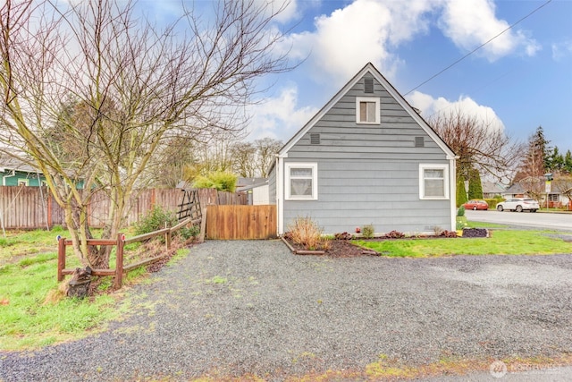 view of home's exterior featuring fence