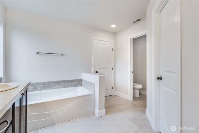 full bathroom with vanity, a bath, visible vents, baseboards, and toilet