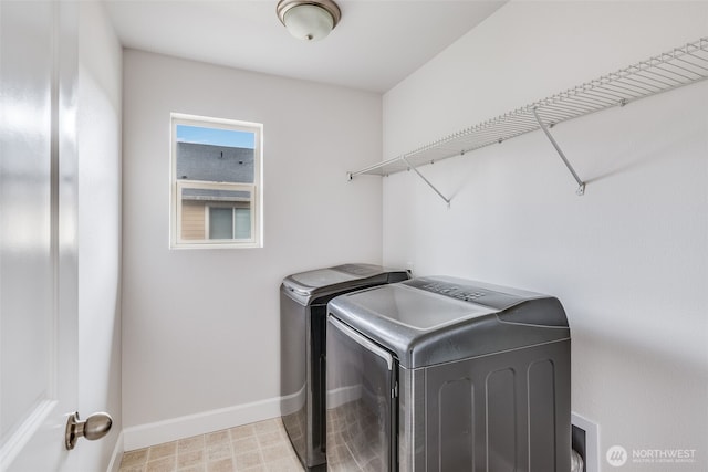 laundry room with laundry area, independent washer and dryer, light floors, and baseboards