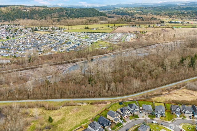 birds eye view of property with a residential view and a wooded view