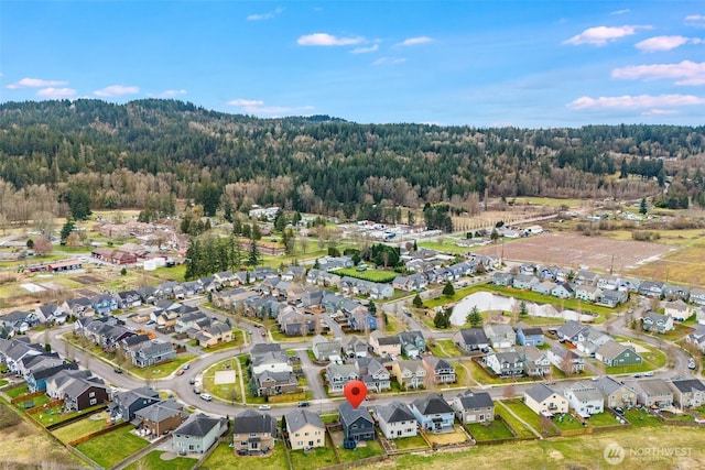 birds eye view of property with a residential view and a view of trees