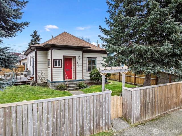 bungalow with a pergola, a wooden deck, and a front yard