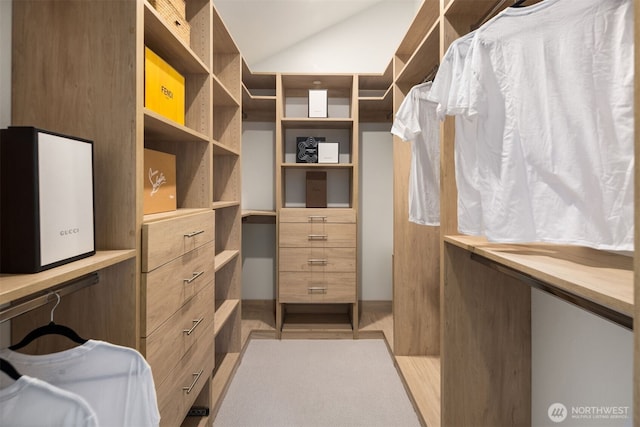 walk in closet featuring lofted ceiling