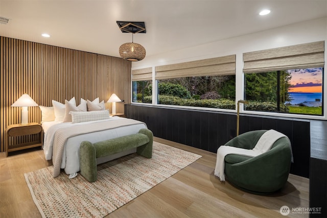 bedroom with light wood finished floors, visible vents, and recessed lighting