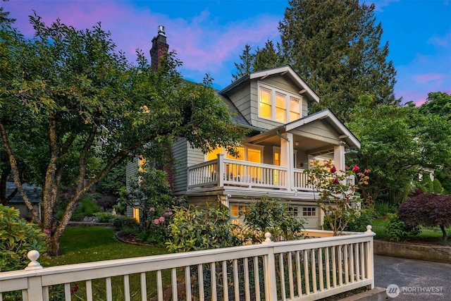 view of front of house with a lawn and a porch